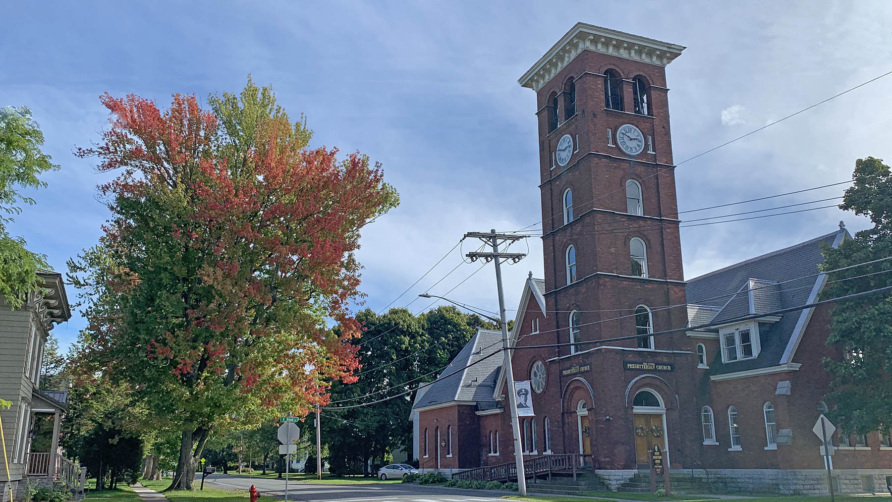 Photo of the United Presbyterian Church at the corner of South Broad and East Main Streets in Sackets Harbor in the fall