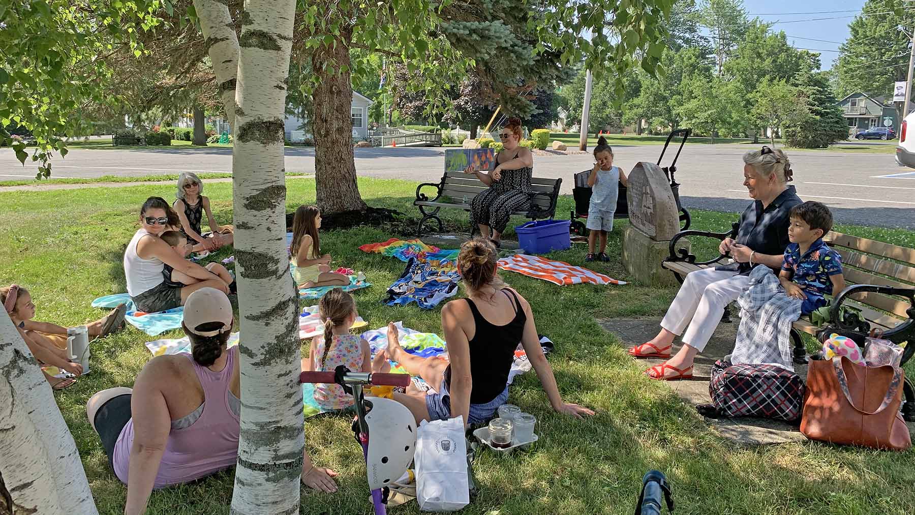 Photo of children and parents attending Story Time on the side lawn of the Visitor Center in 2023
