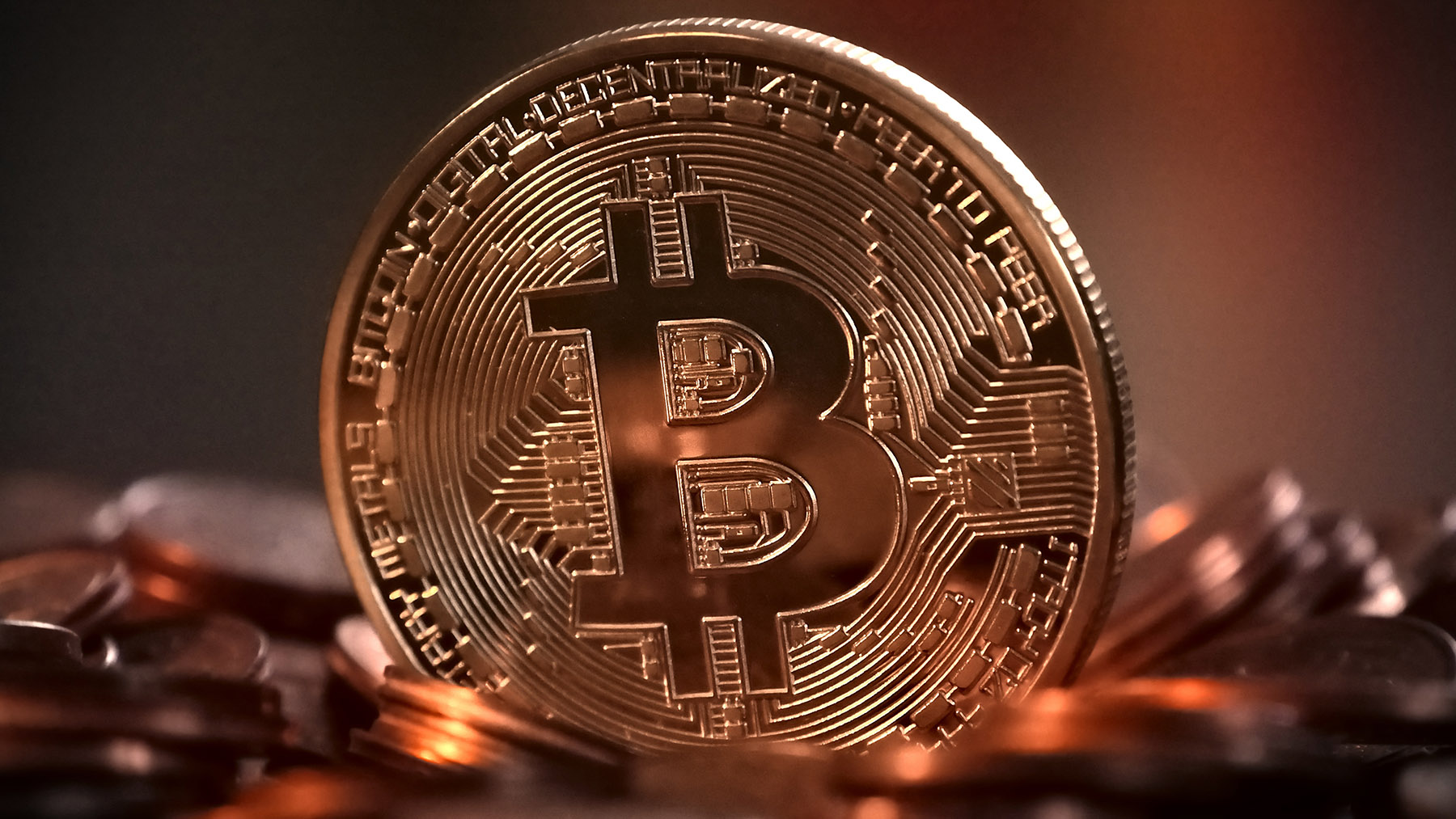 Photo of coins with the bitcoin symbol on them (Image from Creative Commons, courtesy of RawPixel.com)
