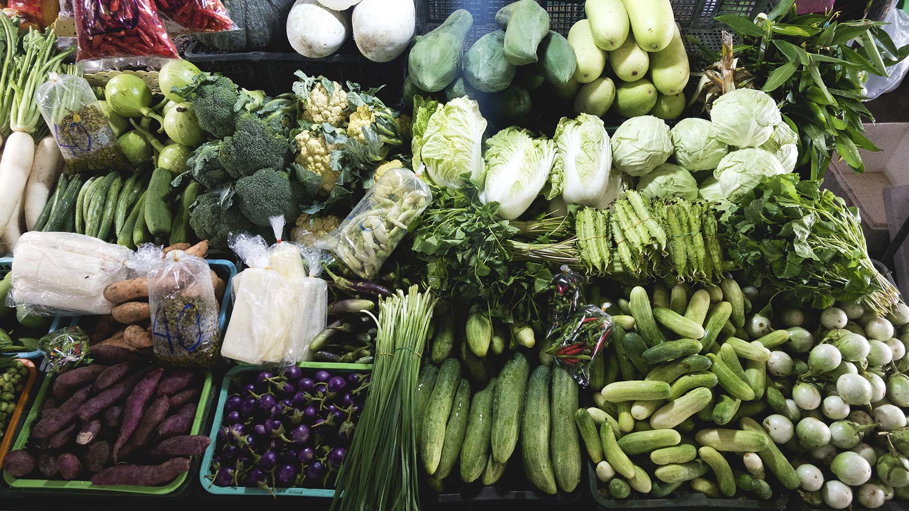 Stock photo of green vegetables at a farmers market stand (Image by RawPixel.com)