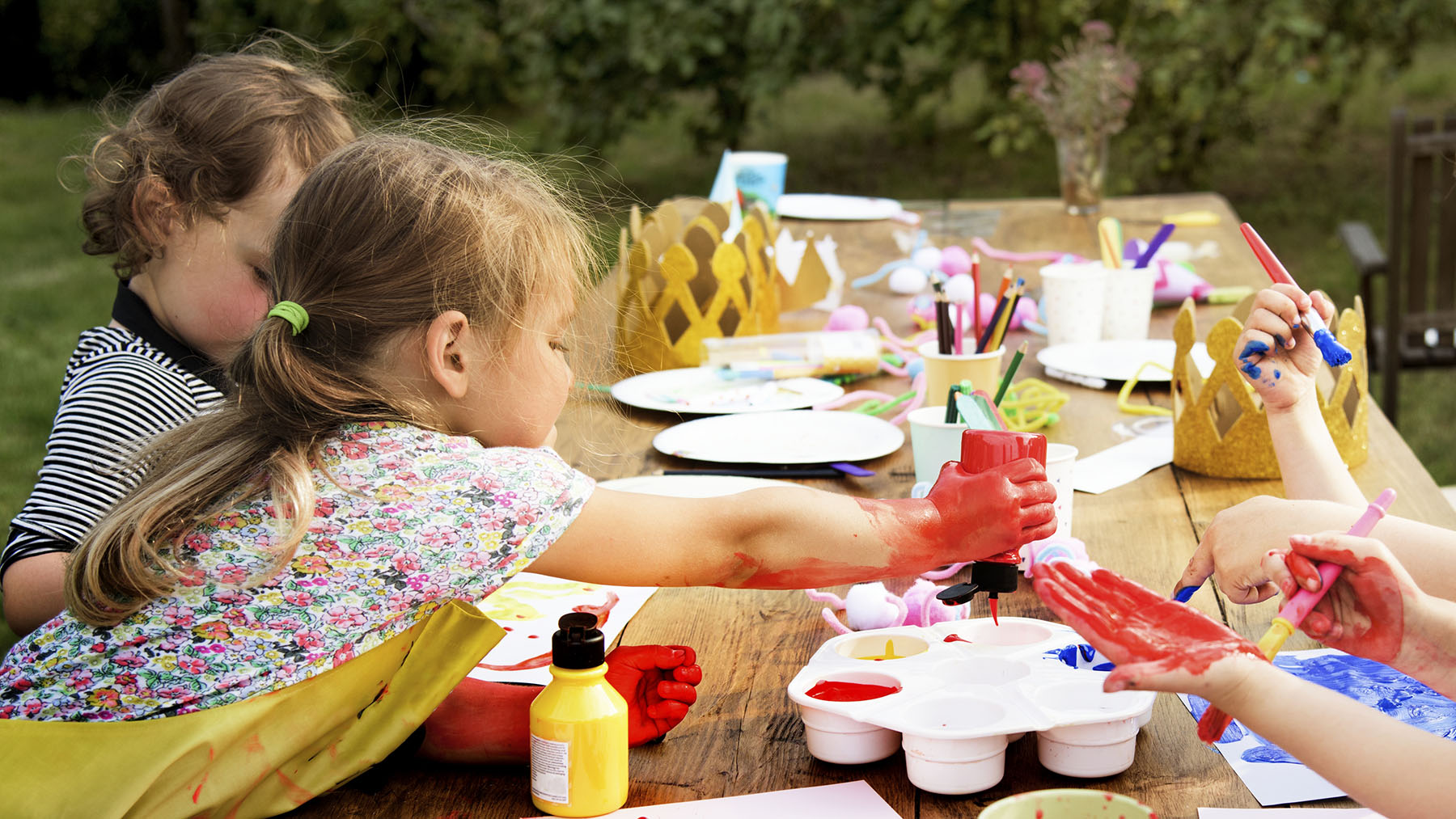 Stock photo of kids doing crafts outdoors (Image by RawPixel.com)