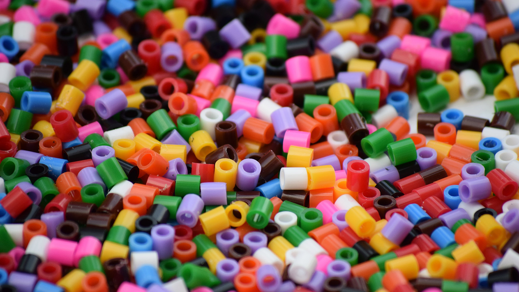 Photo of colorful plastic beads (Creative Commons image, courtesy of RawPixel.com)